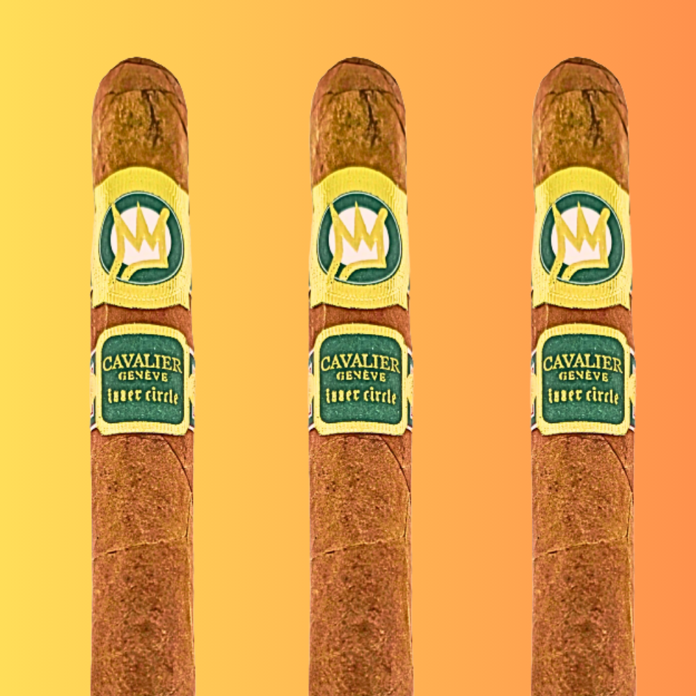 Three Cavalier Genève The Green Jacket 2025 Churchill cigars with Honduran Claro wrapper and gold crown bands on gradient background