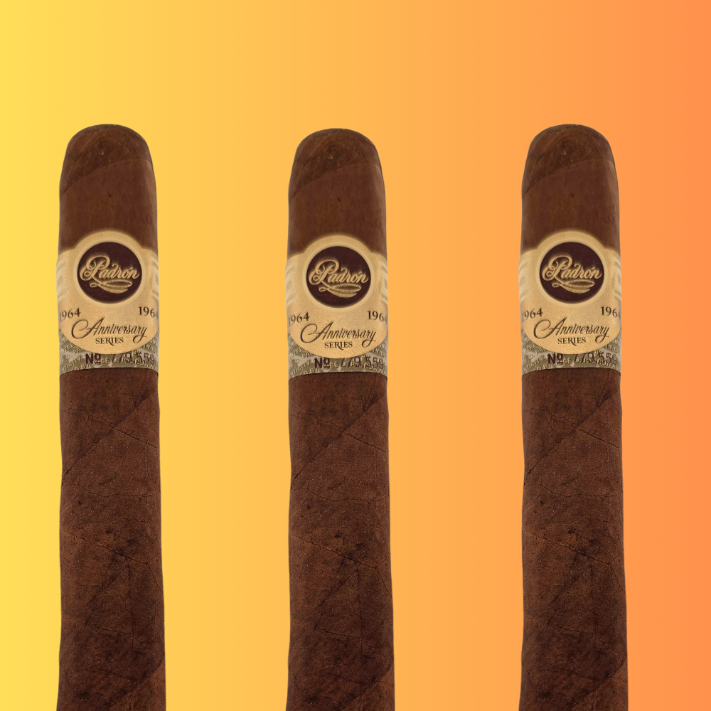 Three Padron 1964 Anniversary Series Presidente cigars with Nicaraguan Maduro wrapper and gold anniversary bands on gradient background