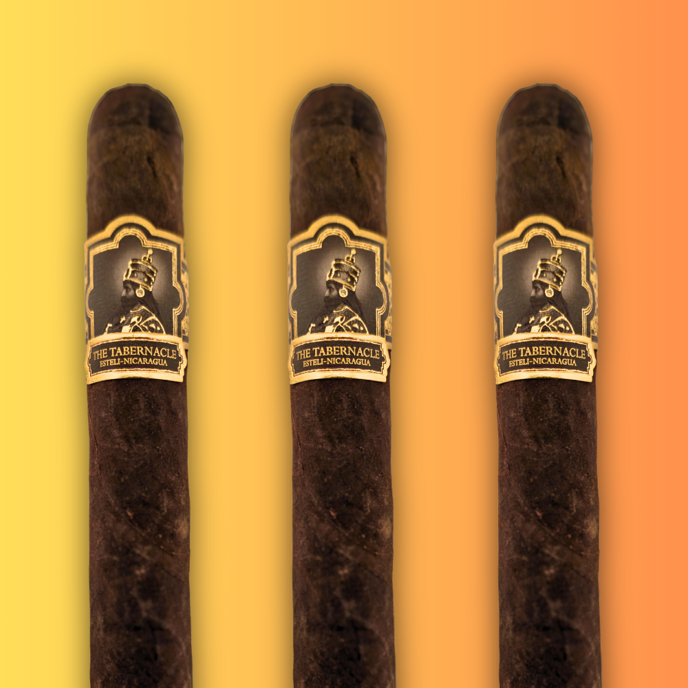 Open box of Foundation Tabernacle cigars with ornate gold and red branding and dark brown wrappers.