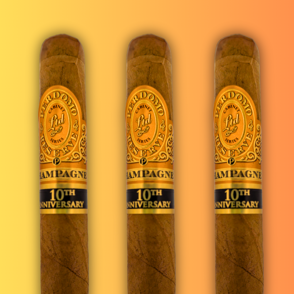 Three Perdomo Reserve Champagne cigars displayed against warm gradient background highlighting smooth Connecticut wrapper and anniversary celebration bands