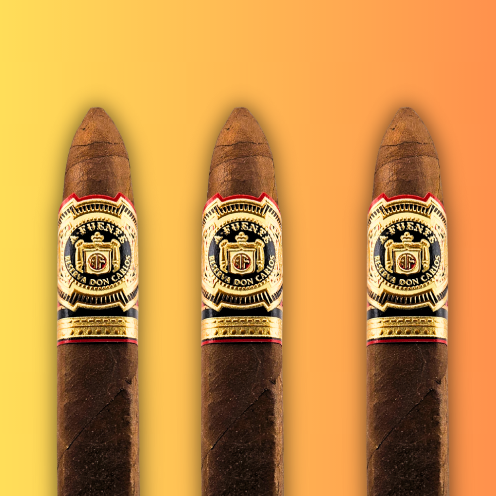 Three cigars with golden branding and Arturo Fuente logo on a gradient yellow to orange background